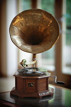 an old fashioned record player sitting on top of a table