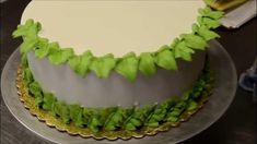 a white and green cake sitting on top of a table