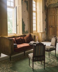 a living room filled with furniture and large windows