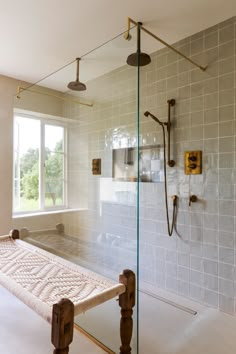 a bath room with a bench and a shower