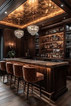 an elegant bar with brown velvet chairs and chandelier hanging from the ceiling above it