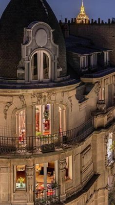 an ornate building with balconies lit up at night