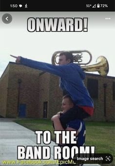 a boy is upside down on his friend's head while he plays the trumpet