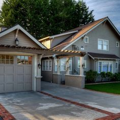 a large house with two garages in front of it