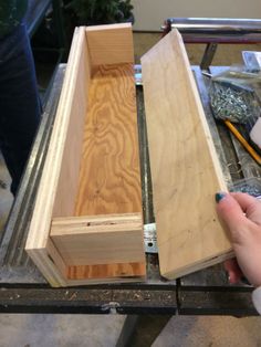 someone is working with wood to make a box out of plywood and other materials