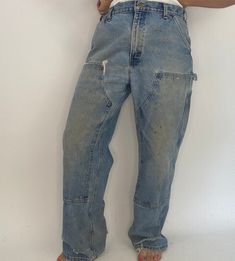 Vintage distressed Carhartt double knee denim work pants. Brown lining. Sold as is. Distressed vintage condition- well worn in with oil and paint stains up front and back noted in photos.  Large rip at front right pocket as well as holes at ankes. Labeled size: 36 x 32 Measured: Waist: 36" Hip: 42" Length: 31" Vintage Distressed Cargo Jeans For Streetwear, Vintage Washed Straight Leg Cargo Jeans, Vintage Dark Wash Washed Cargo Jeans, Vintage Dark Wash Cargo Jeans, Vintage Faded Distressed Pants, Faded Distressed Vintage Pants, Double Knee Pants, Carhartt Double Knee, Knee Pants