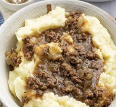 a bowl filled with mashed potatoes and meat