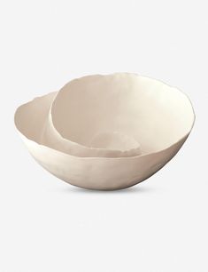 two white bowls sitting on top of each other