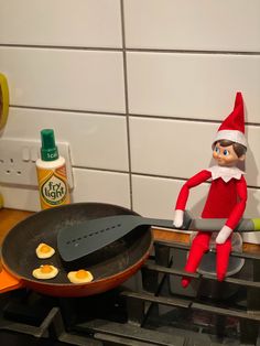 an elf is cooking eggs in a frying pan