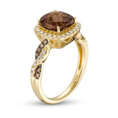 a gold ring with brown and white diamonds on the band, set in 18k yellow gold