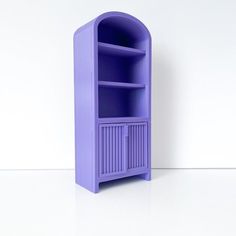 a purple shelf sitting on top of a white floor