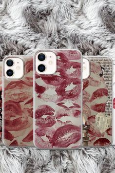 three cases with lipstick prints on them sitting on a furnishing area next to each other