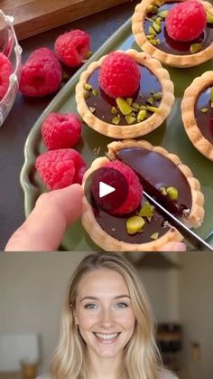 a woman is making desserts with raspberries on top and chocolate in the middle