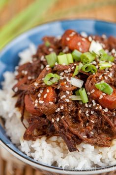 a blue bowl filled with rice and meat