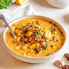 a white bowl filled with soup and vegetables