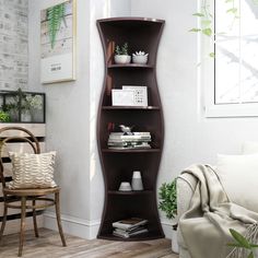 a corner shelf in the corner of a living room next to a chair and potted plant