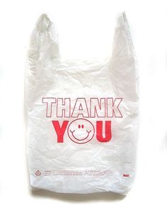 a plastic bag with the words thank you written on it and a smiley face in red