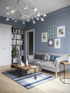 a living room with blue walls and white furniture in the corner, including a gray couch