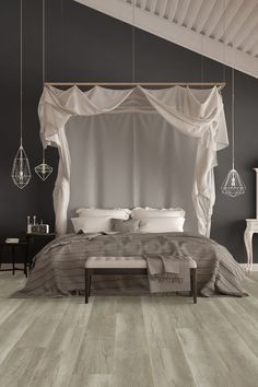 a large bed sitting under a canopy in a bedroom