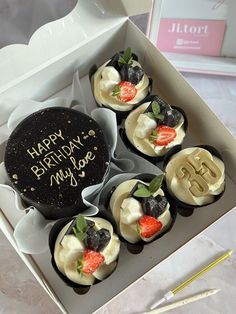 an open box with some cupcakes in it