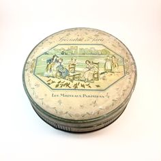 a round tin with an image of people sitting at a table