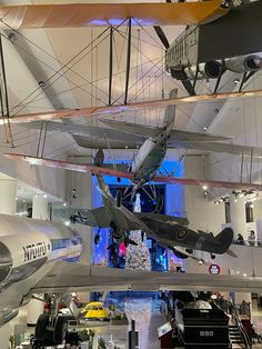 an airplane hanging from the ceiling in a museum