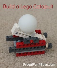 a white ball sitting on top of a red and black lego car with the words build a lego catapult above it