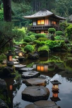 a japanese garden with stepping stones leading to a small building in the middle of it