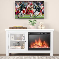 an entertainment center with a television and fire place in front of the tv on top of it