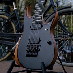 an electric guitar sitting on top of a stand