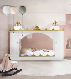 a child's bedroom with pink walls and gold accents