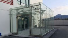 an entrance to a building with glass walls