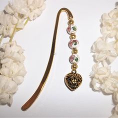 a pair of brooches is laying next to some flowers and white carnations