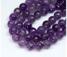 a strand of amethtite beads on a white background