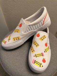 Custom teacher shoes made with a hand-painted design on memory foam slip-on sneakers. Perfect for expressing your love for teaching and showing your creative and colorful side! Hand Painted Sneakers, Van Shoes, Teacher Shoes, Painted Sneakers, Women's Slip Ons, Painted Clothes, Painted Shoes, Slip On Sneakers, Vans Shoes