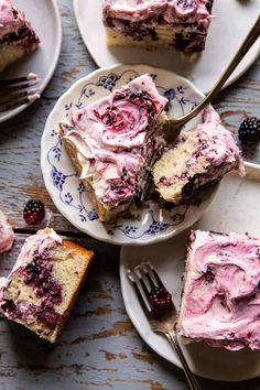 slices of cake with pink frosting and blackberries on plates