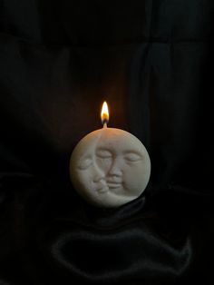 a candle with a face on it in the dark