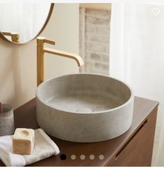 a bathroom sink sitting on top of a wooden counter