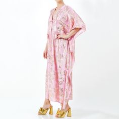 Crafted for the ultimate bohemian goddess, this ethereal maxi caftan combines comfort with effortless style. Ideal for leisurely days or chic outings, this playful dress features a deep V neckline adorned with four tassel shell embellished neckties, offering versatility whether worn open or closed.  This caftan is made from luxurious cotton lawn fabric in a soft pink hue with charming gold lurex flowers woven throughout. Its loose-fitting mu-mu style ensures comfort, making it perfect as a pools Cotton Lawn Fabric, Lawn Fabric, Flirty Dresses, Medium Dress, Alternative Wedding, Independent Designers Fashion, Country Club, How To Feel Beautiful, Bridal Collection