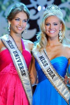 two beautiful women standing next to each other wearing tiaras and gowns on stage