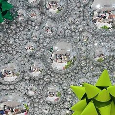 an array of green and silver objects in front of a large mirror ball wallpaper