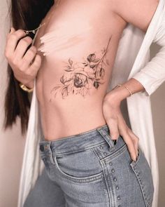 a woman with a flower tattoo on her stomach