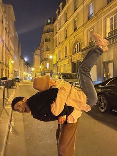 a man doing a handstand on the street