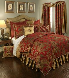 a bed with red and gold comforters in a bedroom