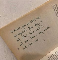 an open book with writing on it and a handwritten note in the bottom corner