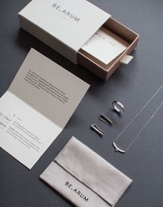 the contents of a jewelry set are laid out on a gray surface, including necklaces and bracelets