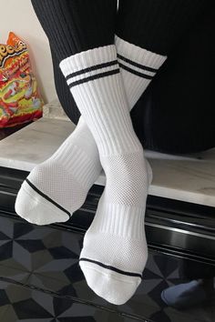 Le Bon Shoppe Boyfriend socks in classic white with black stripes. Stay fly all year long in these calf length sports socks. Pair with sneakers or sliders. Perfect for work from home. One size fits most. 85% cotton, 13% polyester, 2% spandex. Fair trade made in Korea. PIPE AND ROW Socks With Sneakers Outfit, Boyfriend Socks, The Boyfriend, Sports Socks, Closet Staples, Men Fashion Casual Outfits, White Sock, Sport Socks, Cropped Trousers