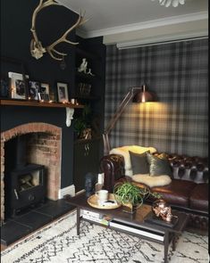 a living room with a couch, chair and fireplace