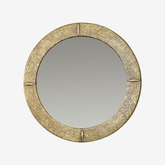 a round mirror sitting on top of a white wall