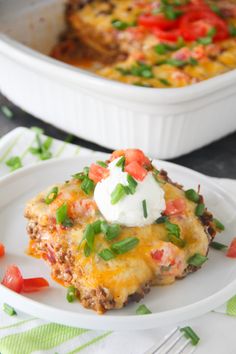 a white plate topped with an enchilada casserole